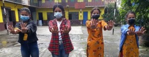 Girls in masks after washing hands